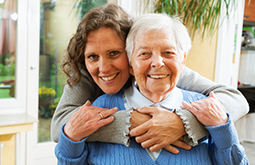 provider of living assistance in Tri-Cities sitting with elderly patient