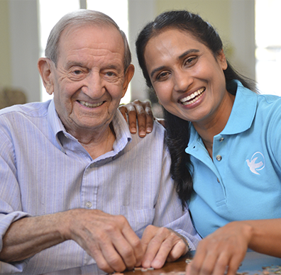 Caregiver and older man doing a puzzle